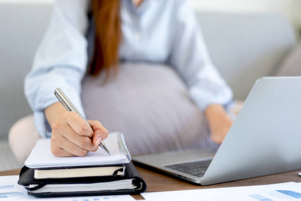 istock Female freelance is typing to search data on laptop and writing information on notebook while sitting 1448354800