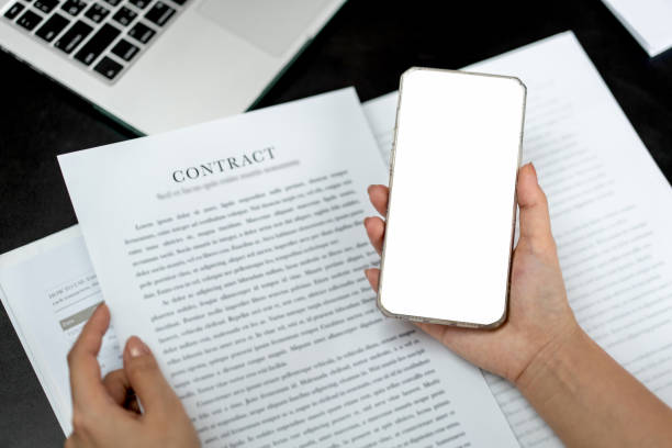 istock Business woman is showing white blank screen on smartphone while checking data and working about new project of business in modern office 1448355308