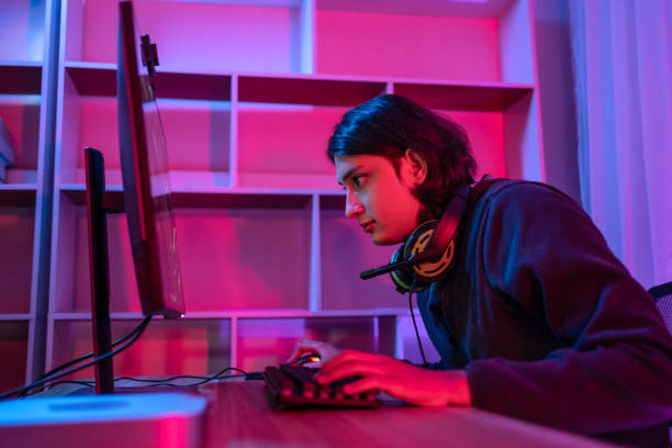 istock Handsome boy playing E-Sport game or streamer, Enjoying playing online games, Entertainment  or technology game trends, Live show play games, Focus monitor, Blue and red lights 1448355332