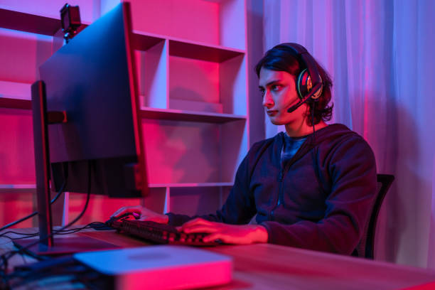istock Handsome boy playing E-Sport game or streamer, Enjoying playing online games, Entertainment  or technology game trends, Live show play games, Focus monitor, Blue and red lights 1448355343