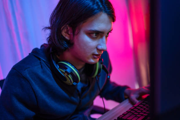 istock Handsome boy playing E-Sport game or streamer, Enjoying playing online games, Entertainment  or technology game trends, Live show play games, Focus monitor, Blue and red lights 1448355592