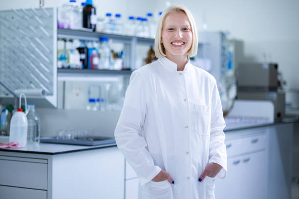 istock Happy female biochemist in laboratory. 1448357527