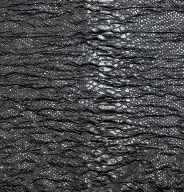 istock Black textured crinkled background. Black wrinkled fabric with lace inserts. 1448357541