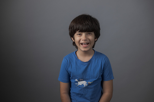 Young multiracial boy Indian-Iranian looking at camera smiling