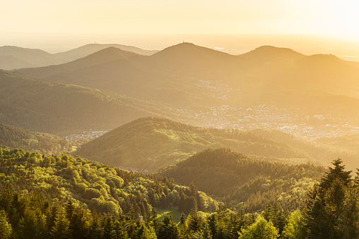 View from Devil's Mill in the Black Forest mountains to the panorama of Murg Valley and Rhine Valley in the evening sun, Baden-Wuerttemberg, Germany