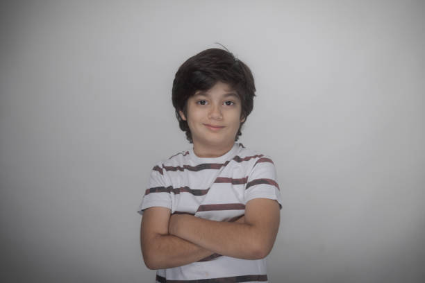Young multiracial boy Indian-Iranian looking at camera smiling
