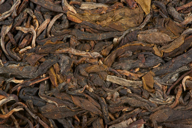 istock Black dry tea leaves isolated on white background. 1448360363
