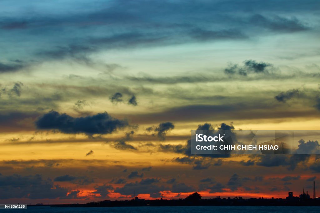 Dramatic sunset Cloudscape with sea and city. Abstract Stock Photo