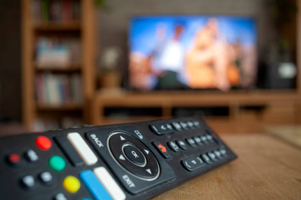 Remote Control of Television Remote Control of Television before TV screen. remote controlled stock pictures, royalty-free photos & images