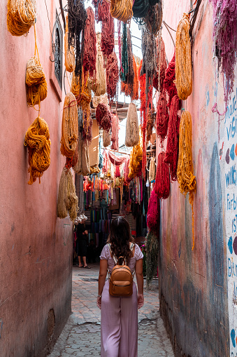 A girl in the Marrakech market visits a cloth production