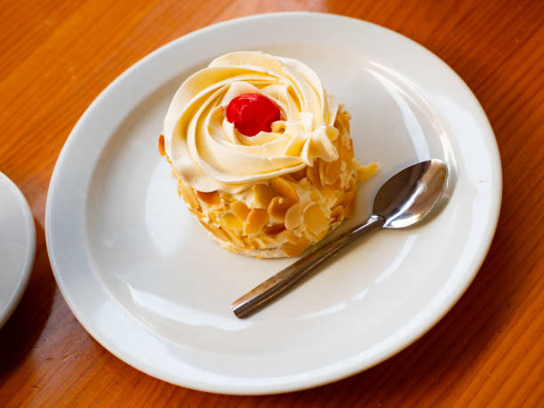 istock Sponge cake with vanilla frosting and almonds 1448363149