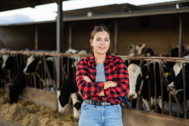 istock Farmer engaged in breeding of cows posing in cowshed 1448363925