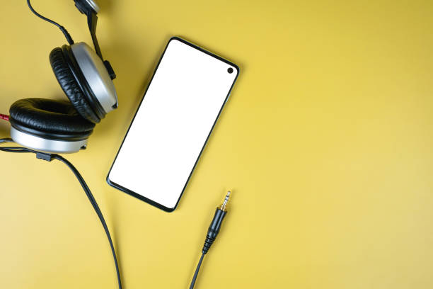 istock Smartphone with white mockup with headphones on yellow background 1448364032