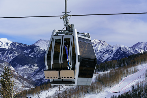 Skier Gondola and Scenic Gore Range Views Vail Colorado - Scenic gondola going up mountain with dramatic mountain views in background.