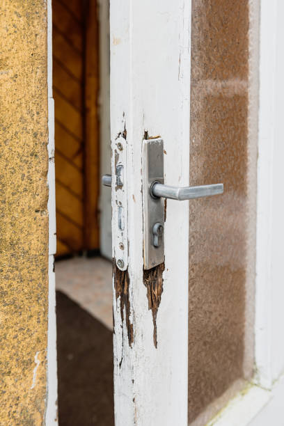 istock Old worn white wooden door with handle and glass. 1448367068