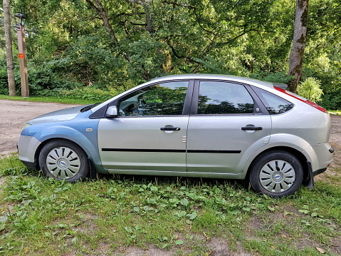 Kuldiga, Latvia - August 3, 2022: Ford Focus car in silver color with with different colored front wings.