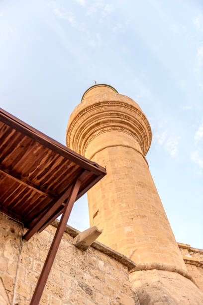 The minaret of an old mosque in the town of Kyrenia in Cyprus seen at sunset