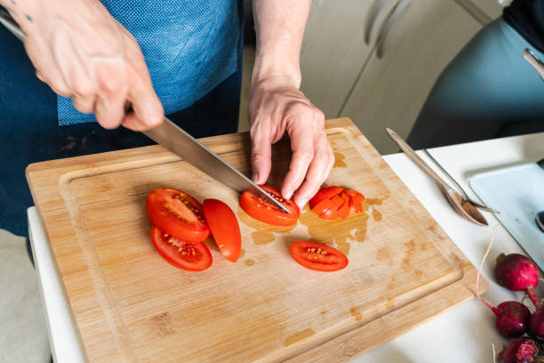 istock Person cutting vegetables on a chopping board 1448371506