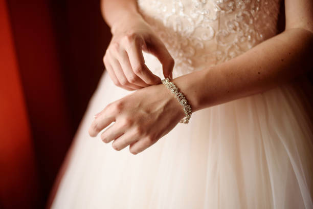 istock The bride dresses the bracelet in her hands 1448371814