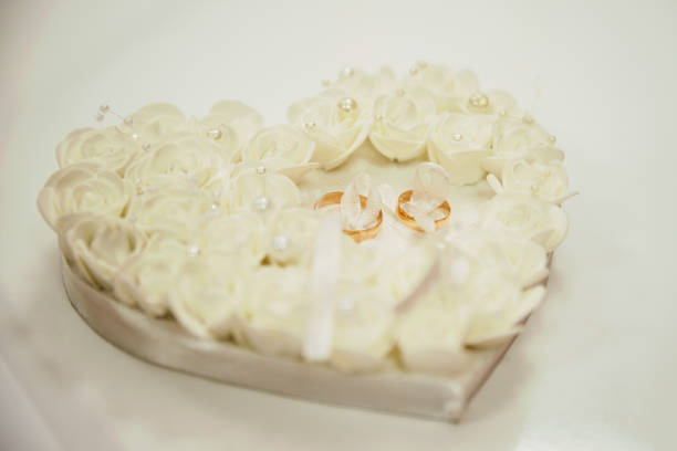 wedding rings lie on a decorated heart. High quality photo