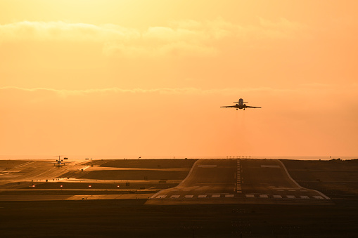 Small airplanes on the runway at sunset