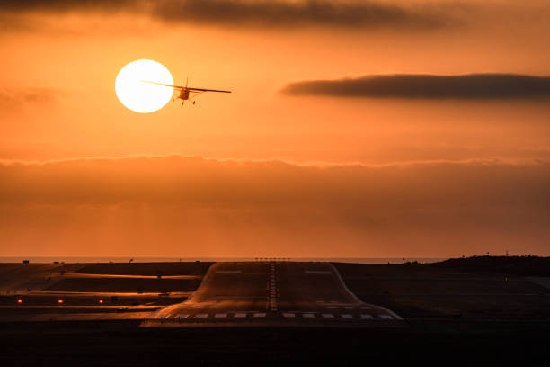Small airplane single propeller in flight taking off at sunset