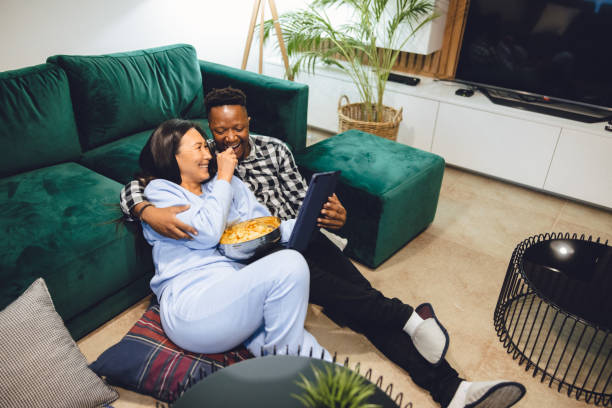 istock Multiracial heterosexual couple enjoying media at home 1448374412