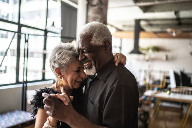 Senior couple dancing waltz in dance hall