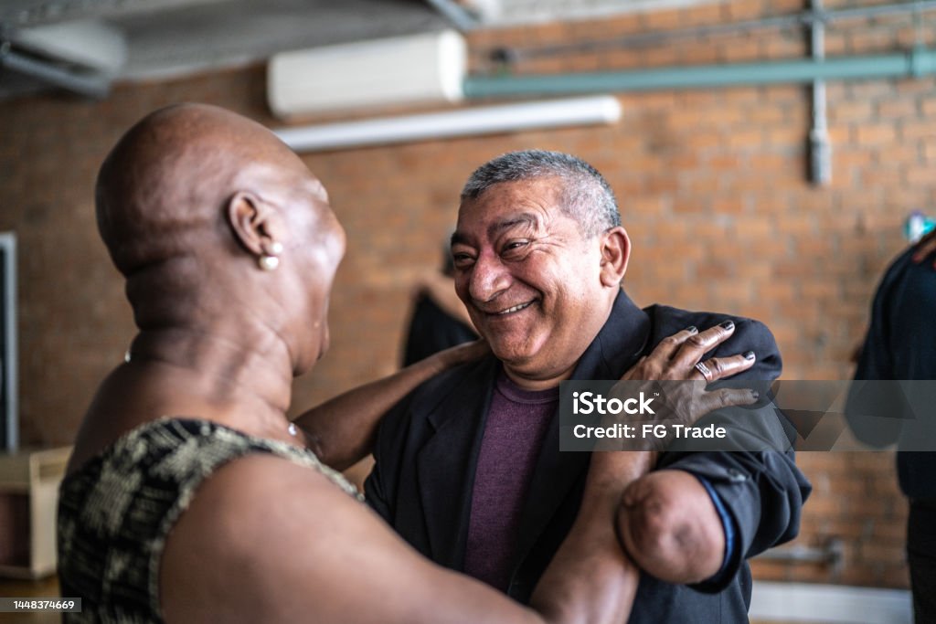 Amputee mature man dancing with his wife in dance hall Disability Stock Photo