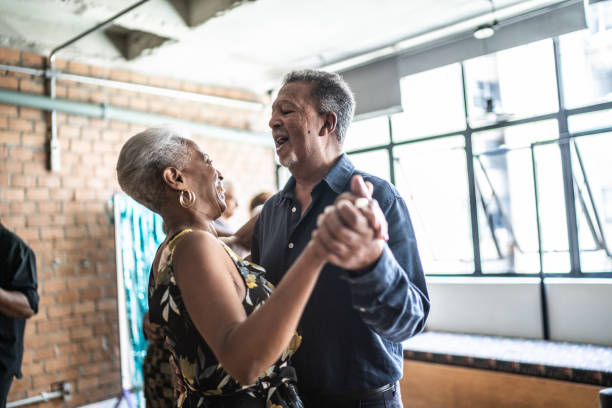 Senior couple dancing waltz in dance hall