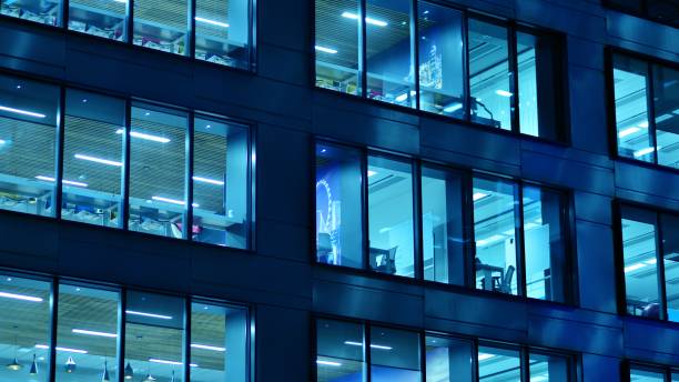 istock Pattern of office buildings windows illuminated at night. 1448375814