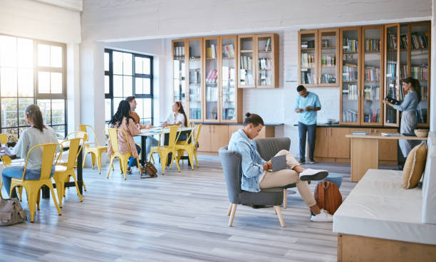 istock Students, men or women in creative library on university campus, school or college for education, study or learning. Diversity, people and young business entrepreneurs with scholarship research books 1448375957