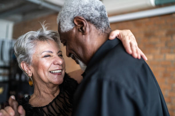 Senior couple dancing waltz in dance hall