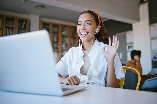 Laptop webinar, video call meeting on online zoom call in library, school or classroom. Wave, student or woman happy or greeting on webinar training or education presentation class with smile