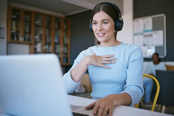 istock Video call, presentation and student with laptop and headphones talking in virtual class discussion at university library or workspace. College woman teacher in virtual zoom call for elearning course 1448377441