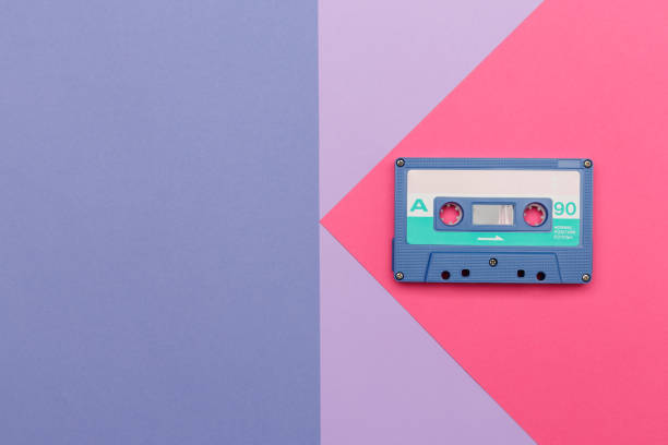 istock Blue audio cassette on a pink and lilac background. 1448381099