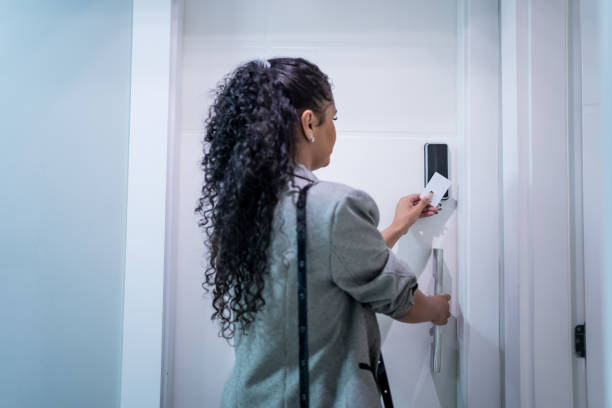istock Woman using electronic card to open the door 1448382369