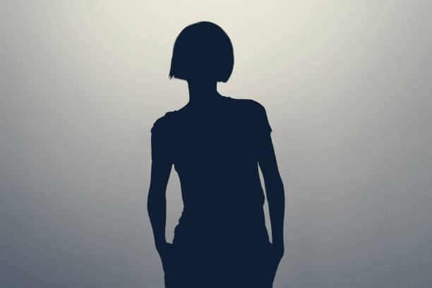 istock Unknown female person silhouette in studio. Anonym unrecognizable woman. 1448383175