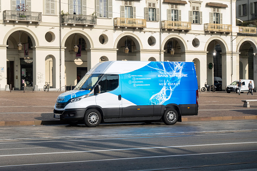 Turin, Italy - 27th October, 2022: Electric delivery van IVECO eDaily on a street in a city center. The Daily is a large light commercial van produced by the Italian automaker Iveco since 1978.