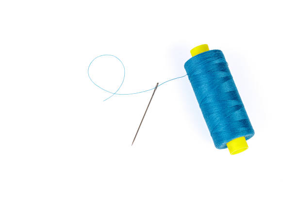 istock Macro skein of blue thread with a needle on a white background 1448383799