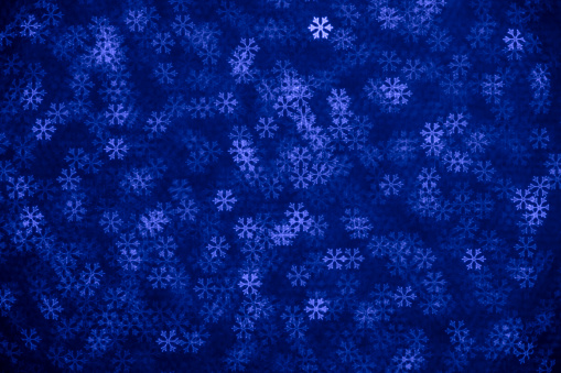 DSLR photo - defocused bokeh with snowflakes shape. Space for copy. Can be used as a Christmas background. It's a real bokeh photo, not an illustration or computer effect.