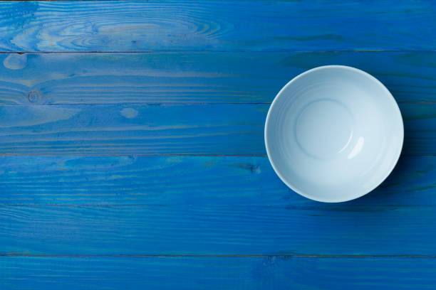 istock Empty round plate on wooden background, top view 1448384799