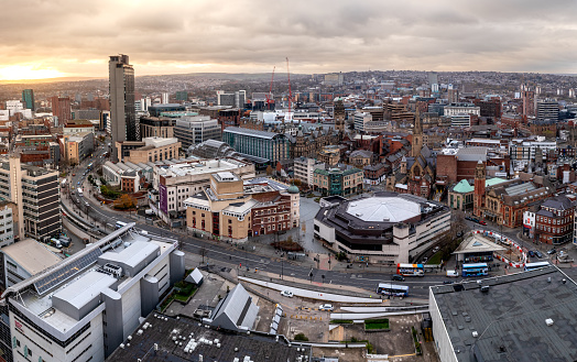 Sheffield, UK - December 6, 2022.  An aerial panorama of Sheffield city centre cityscape skyline at sunset with The Arts Tower and Crucible Theatre in the retail district