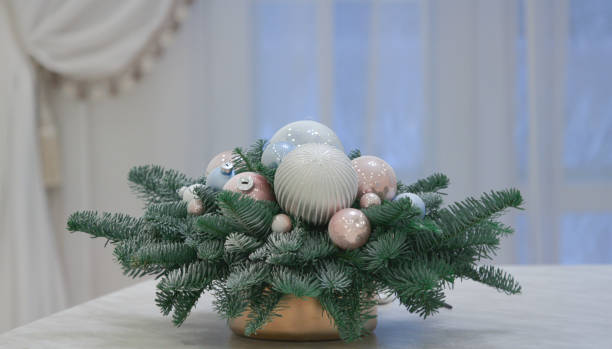 istock Christmas tree branches and Christmas balls in a vase on a table 1448385988
