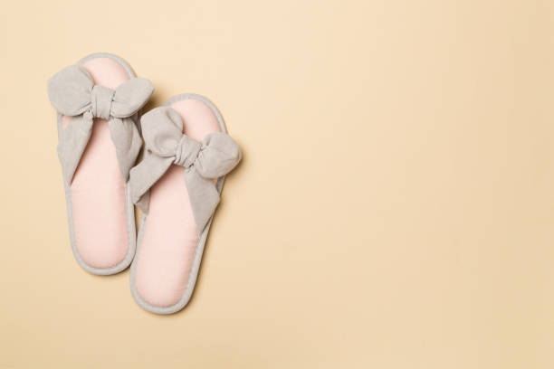 istock Soft pink slippers on color background, top view 1448387134