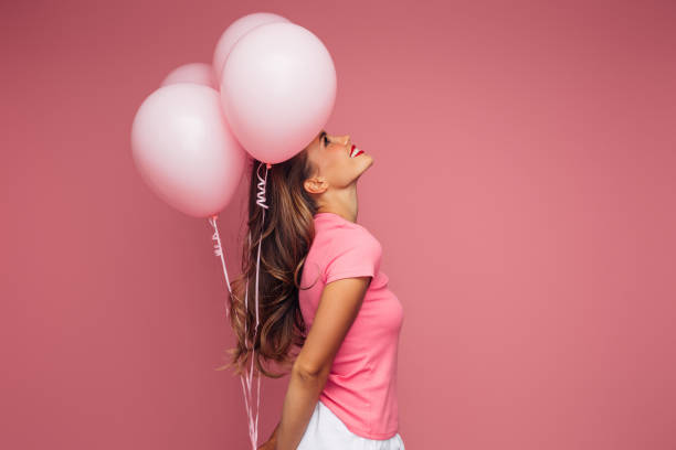 istock Happy beautiful woman with balloons 1448387168