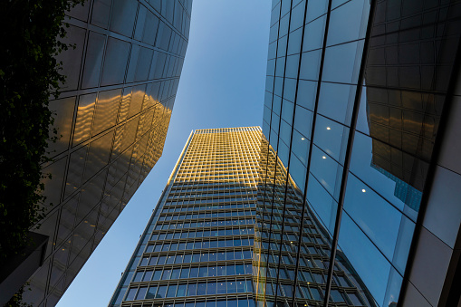 The sky between corporate buildings in the City of London.