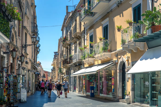 The main street, Corso Umberto, and one of the many side streets through the coastal city of Taormina, Italy on the island of Sicily Taormina, Sicily, Italy - July 23, 2020: The main street, Corso Umberto, and one of the many side streets through the coastal city of Taormina, Italy on the island of Sicily noto sicily stock pictures, royalty-free photos & images
