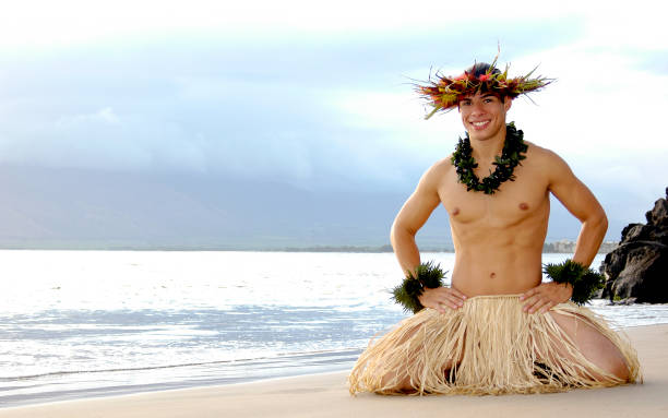 istock Male Hula Dancer smiles as he kneels on the beach in a hula dance pose. 1448393667
