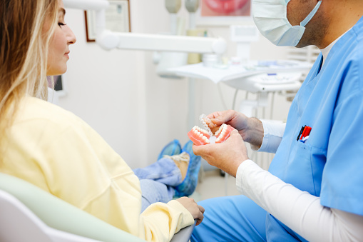 Male Dentist with denture in the dentistry's office